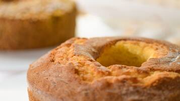 A close-up of a baked good with a golden-brown crust and a hollow center.