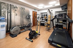 A gym with various exercise equipment including treadmills, an elliptical, and a rowing machine. - Holiday Inn Milan - Garibaldi Station by IHG (Milan)
