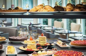 A buffet with various desserts including cakes, pastries, and fruit-topped pancakes. - Holiday Inn Milan - Garibaldi Station by IHG (Milan)