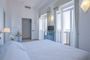 Minibar, desk, laptop workspace, bed sheets