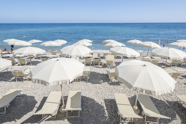 On the beach, sun loungers, beach umbrellas