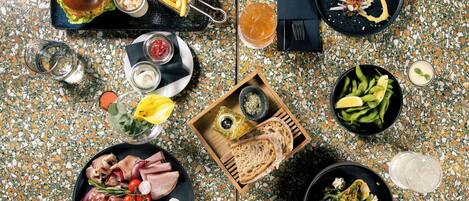 A top-down view of a dining table with various food items and drinks.