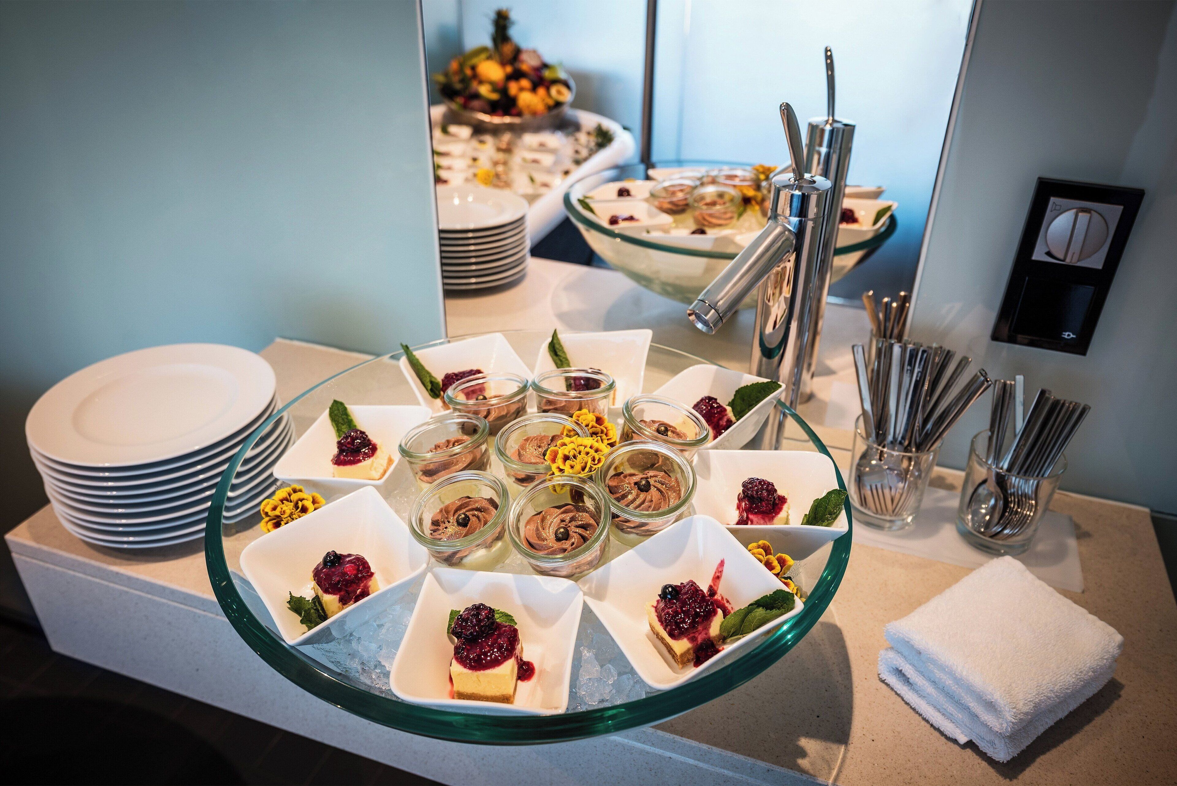 A buffet with various desserts and a glass display case.
