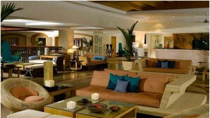 A spacious lobby with a large seating area, a reception desk, and a bar. - The Zuri White Sands, Goa Resort & Casino (Varca)