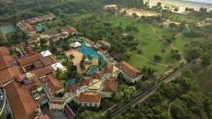 An aerial view of a resort with a swimming pool, golf course, and beach access. - The Zuri White Sands, Goa Resort & Casino (Varca)