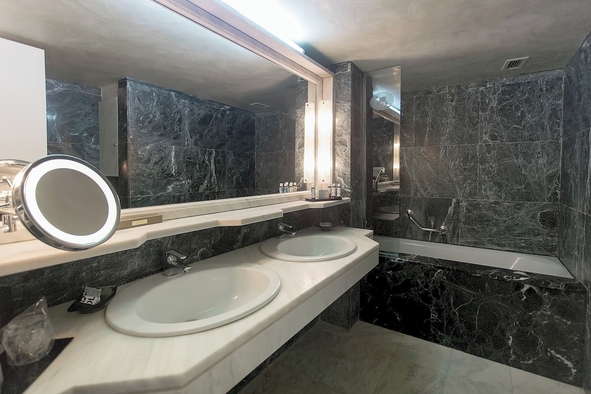 presidential suite sea / mouse island view | bathroom | designer toiletries, hair dryer, slippers, towels