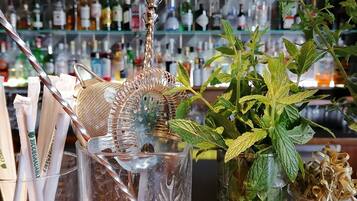 A bar area with a variety of bottles and a decorative metal piece.