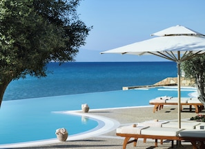 Outdoor pool, an infinity pool, pool umbrellas