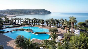 Outdoor pool, an infinity pool, pool umbrellas