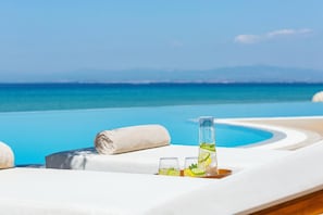Outdoor pool, an infinity pool, pool umbrellas