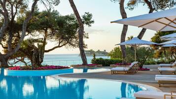 Een seizoensgebonden buitenzwembad, parasols voor strand/zwembad
