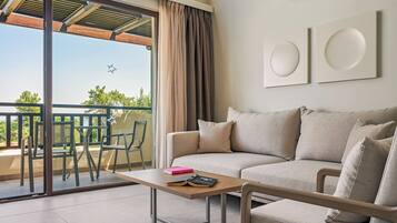 Ein modernes Wohnzimmer mit Sofa, Couchtisch und Balkon mit Blick.