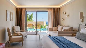 A hotel room with a bed, two armchairs, a sofa, a small table, and a view of a pool and ocean.