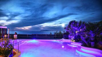 Outdoor pool, a rooftop pool, open 9:00 AM to 7:00 PM, pool loungers