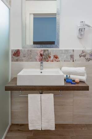 A bathroom with a white sink, a towel rack, and a mirror. - Hotel Maria Serena (Rimini)