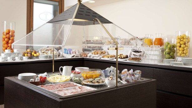 A buffet with various food items, including fruits, cheeses, and meats. - Best Western Titian Inn Hotel Treviso (Silea)