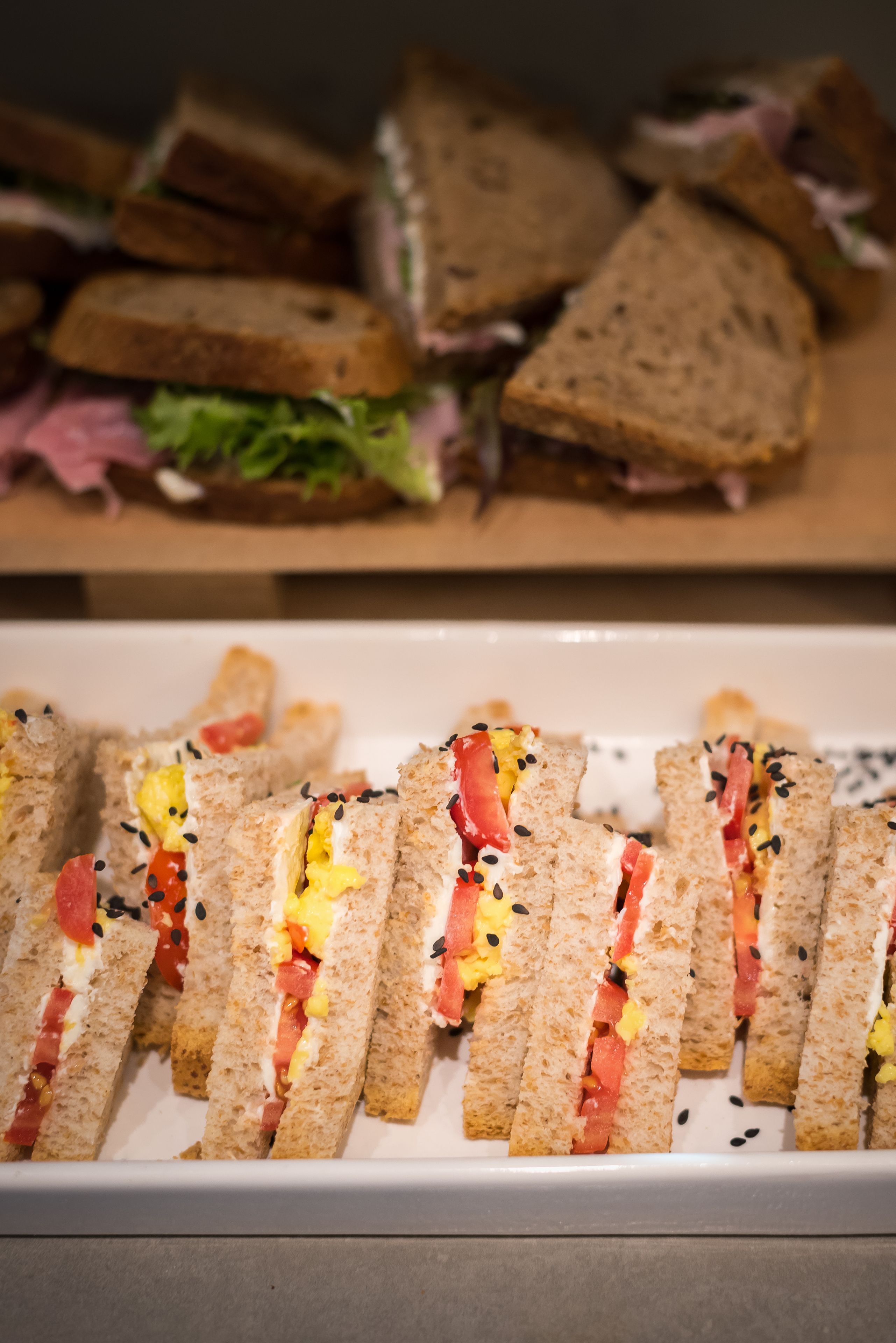 A tray of sandwiches with various fillings.