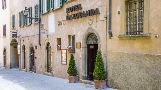 A building with the sign "HOTEL LA LOCANDA" indicating a hotel establishment. - Hotel La Locanda (Volterra)