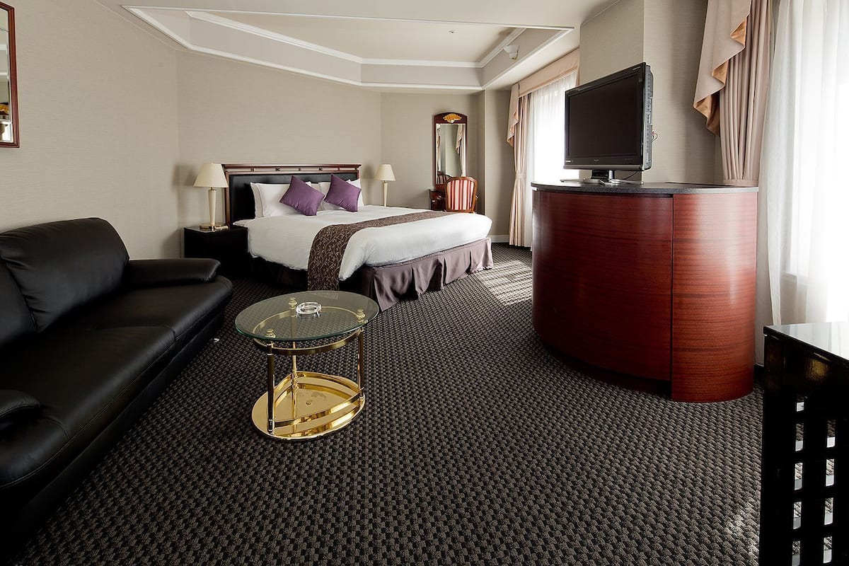 Premium bedding, desk, laptop workspace, iron/ironing board