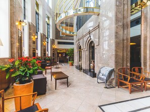A spacious lobby with marble floors, seating areas, and a central staircase. - Kurashiki Royal Art Hotel (Kurashiki)