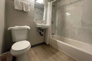 Suite, 1 Queen Bed, Non Smoking | Bathroom | Free toiletries, towels