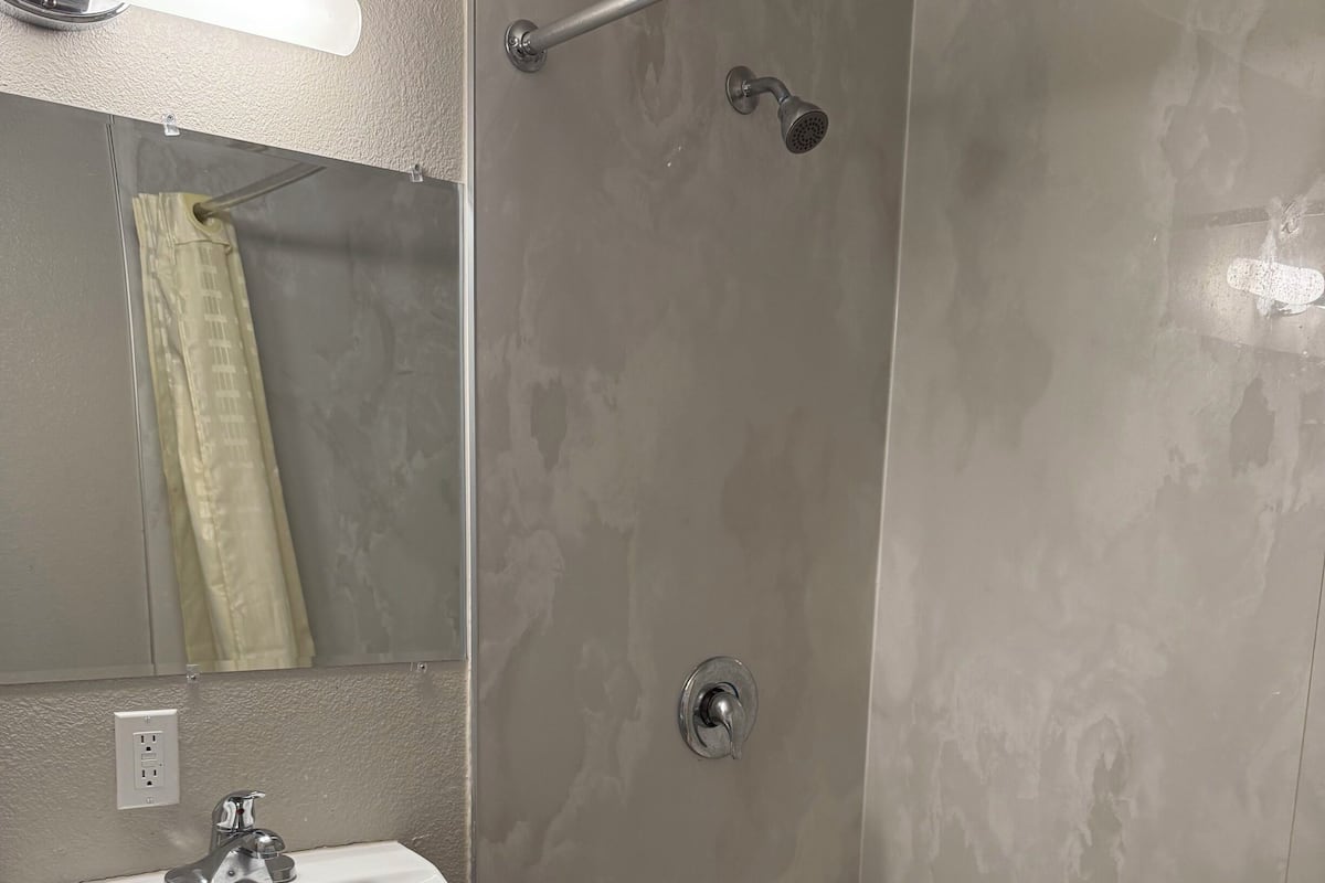 Suite, 1 Queen Bed, Non Smoking | Bathroom | Free toiletries, towels