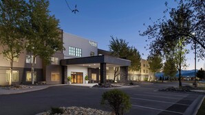 A modern hotel with a stone facade, large windows, and a covered entrance area. - Fairfield by Marriott Inn & Suites Missoula Airport (Missoula)