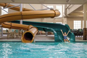 A water slide in an indoor pool area with chairs and tables around. - Fairfield by Marriott Inn & Suites Missoula Airport (Missoula)