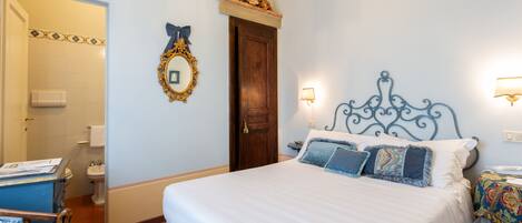 A bedroom with a bed, a dresser, a chair, a mirror, and a door.