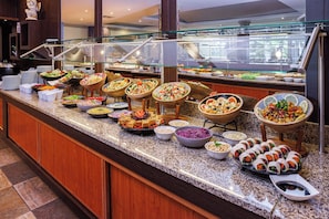 A buffet with various food options, including salads, dips, and wraps. - Pestana Viking Beach & Spa Resort (Lagoa)