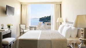 Una camera d'albergo con un letto, una scrivania, una sedia, un tavolo e una televisione.