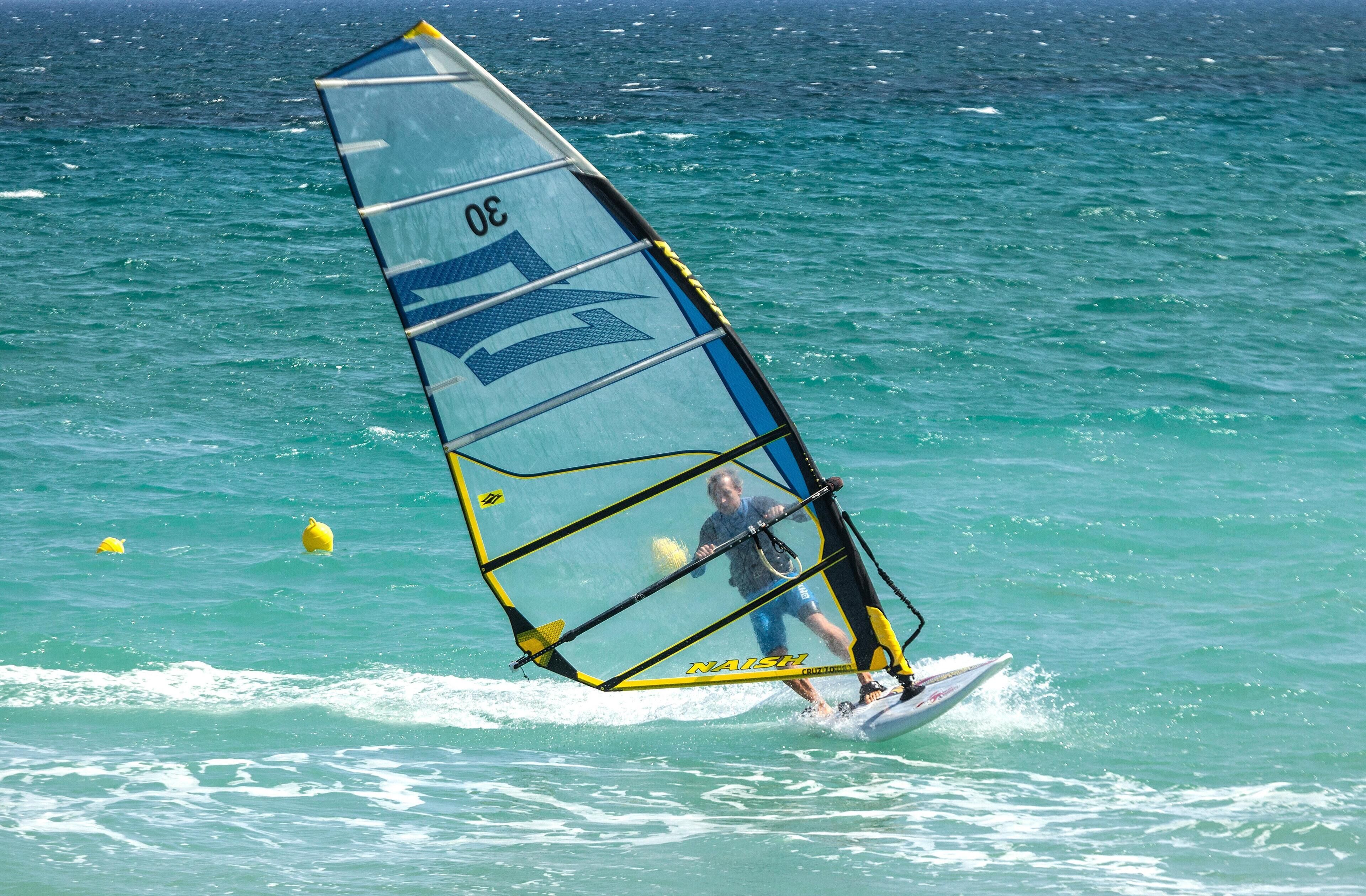 A person windsurfing on a clear day.