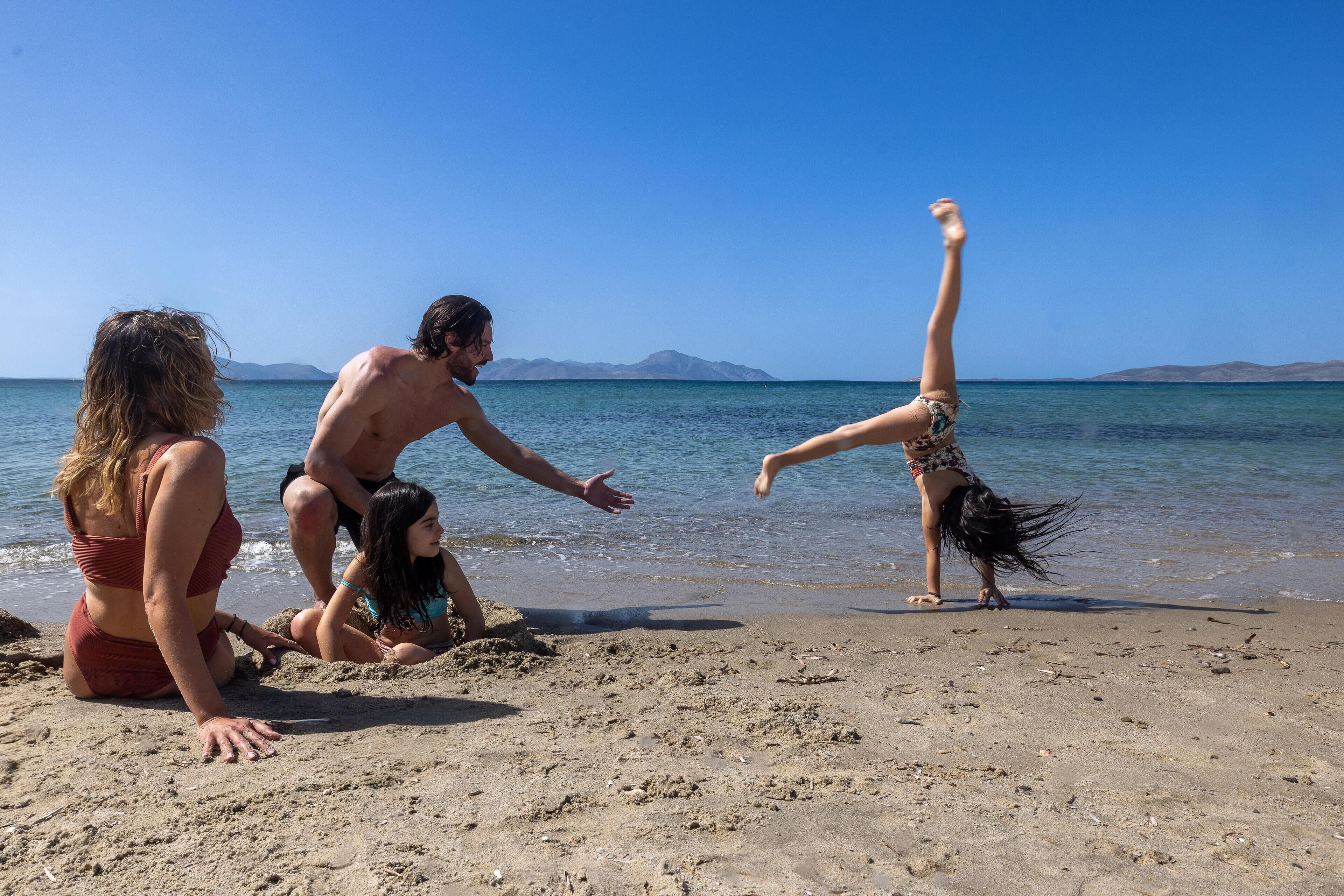 A beach scene with people engaging in activities.