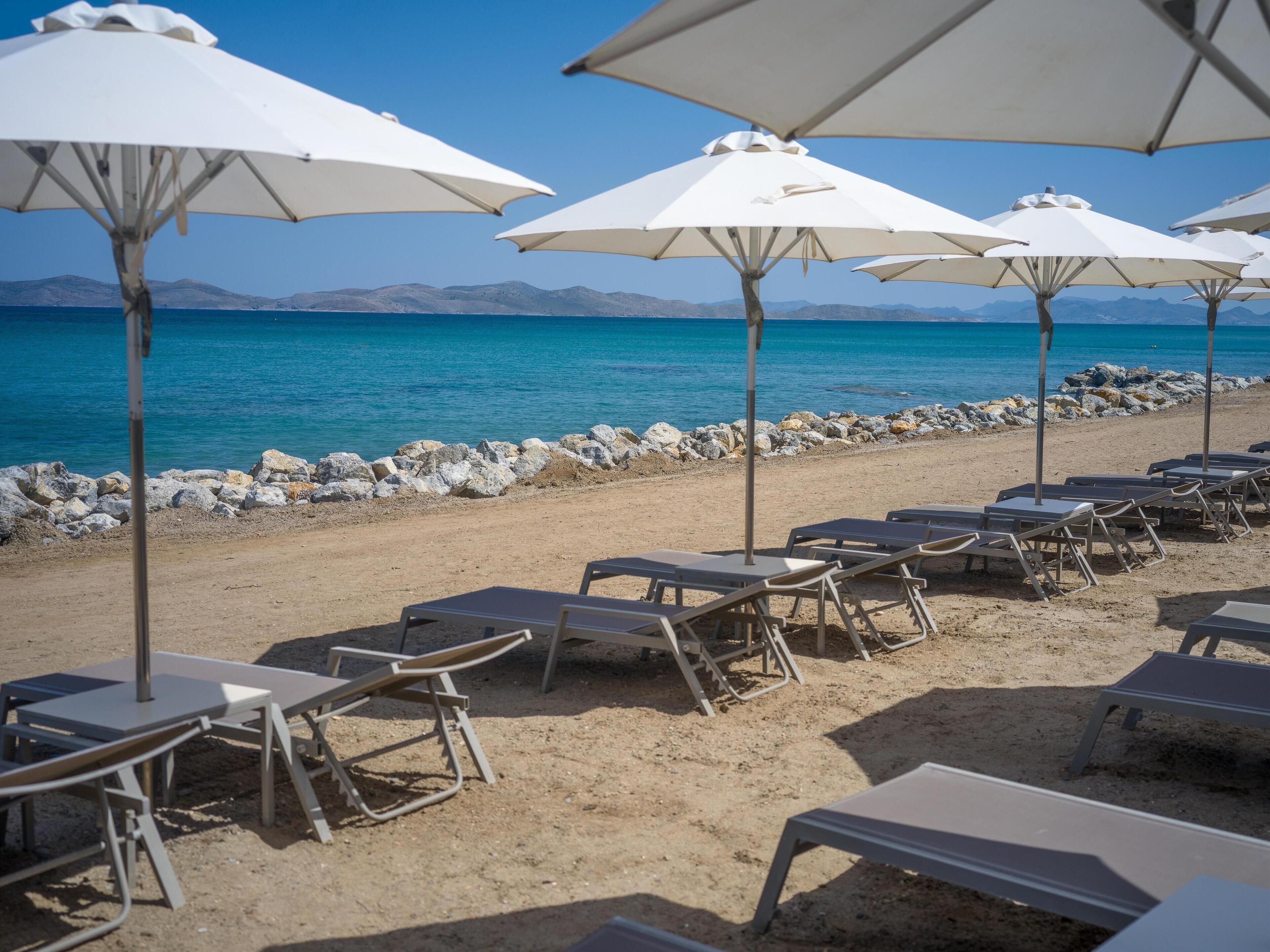 On the beach, sun-loungers, beach umbrellas, beach towels
