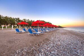 On the beach, sun loungers, beach umbrellas