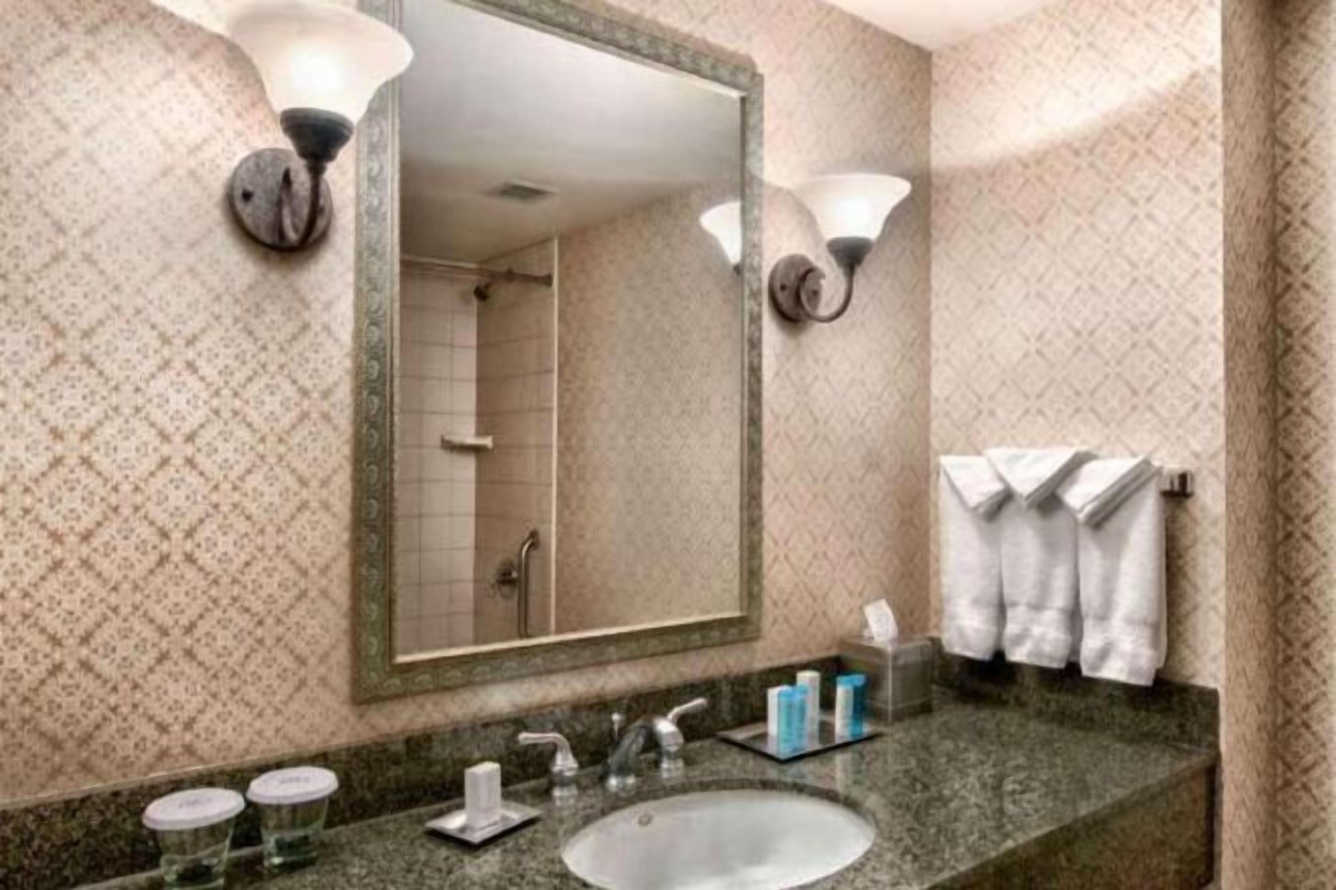 Designer toiletries, hair dryer, towels