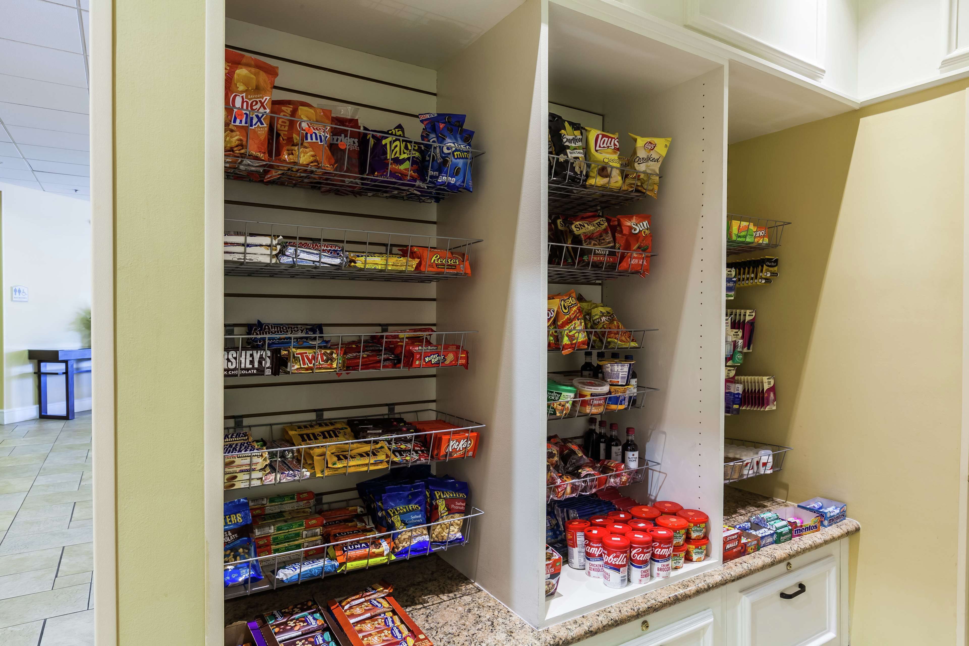 A pantry stocked with various snacks and condiments.