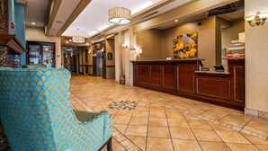 A hotel lobby with a reception desk, patterned chairs, and a tiled floor. - Comfort Inn & Suites Waco Woodway (Waco)