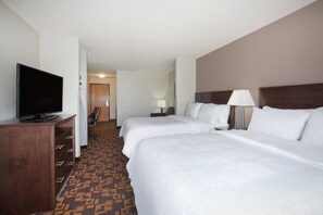 A hotel room with two beds, a TV, a desk, and a patterned carpet. - Holiday Inn Express & Suites Yankton by IHG (Yankton)