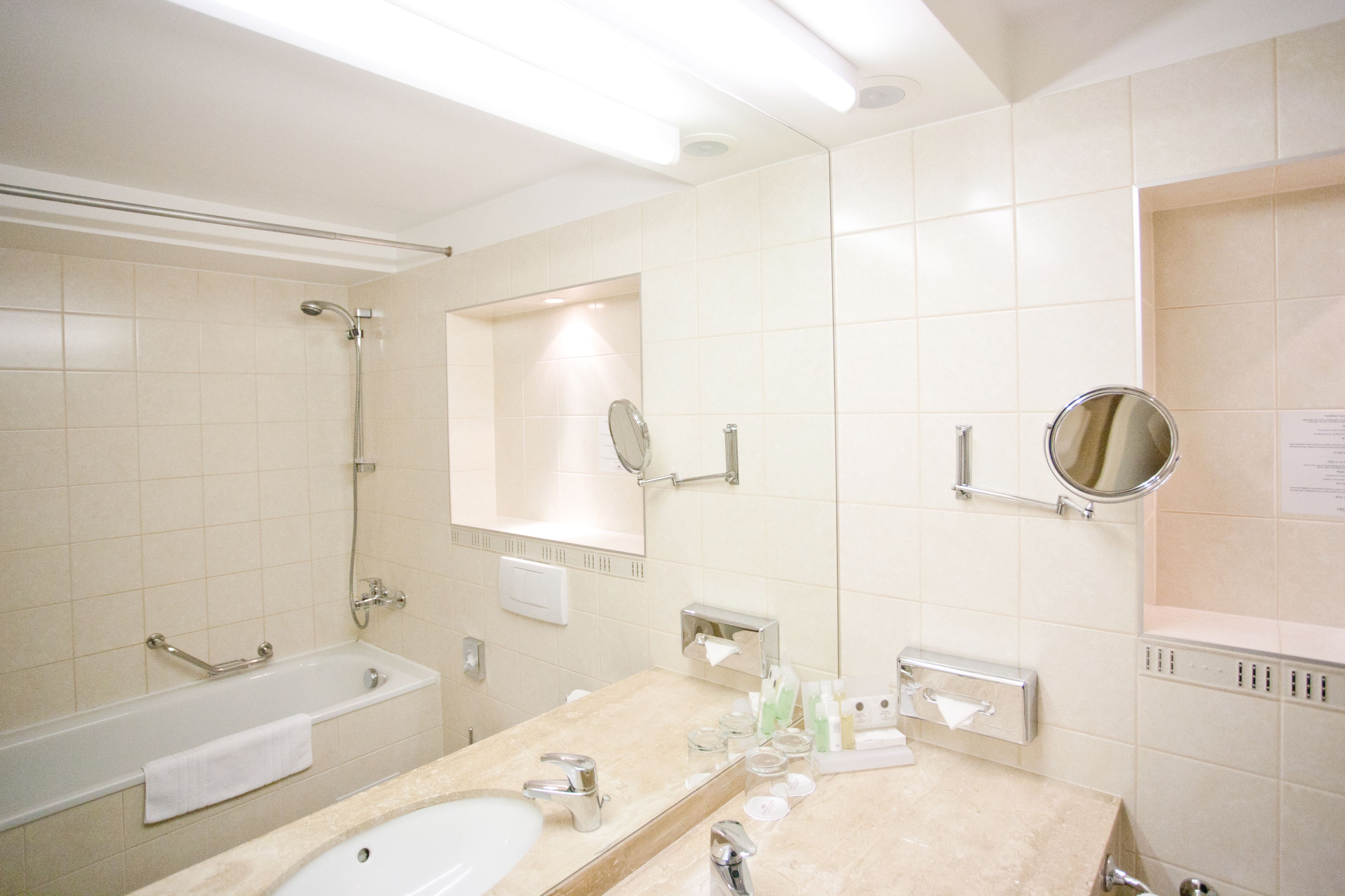 bathtub, free toiletries, slippers, towels