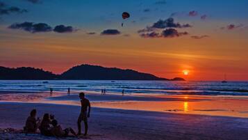 On the beach, white sand, beach towels, beach bar