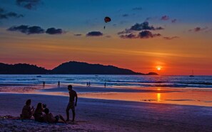 On the beach, white sand, beach towels, beach bar