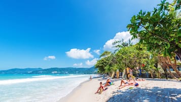 On the beach, white sand, beach towels, beach bar