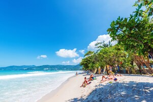 On the beach, white sand, beach towels, beach bar