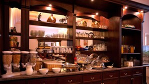 A well-organized kitchen with various food items and kitchenware on shelves and counters. - Hotel Aster (Berlin)
