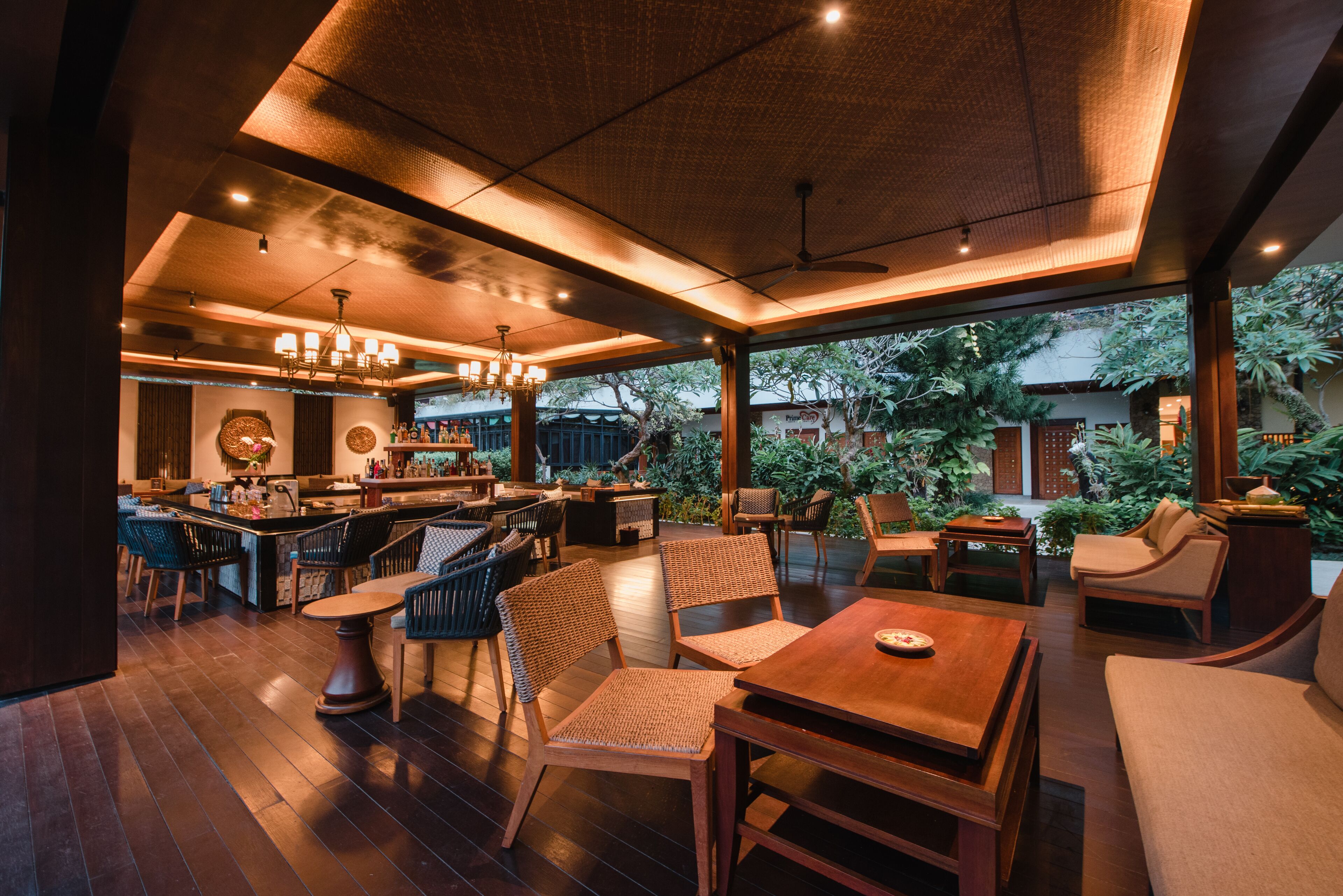 A spacious indoor area with a bar, seating arrangements, and a view of the outdoors.