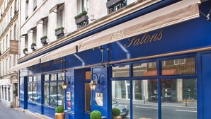 A blue facade of a hotel with the name 'FA Salons' and a sign for 'Hotel France Albion' above it. - Hotel France Albion (Paris)