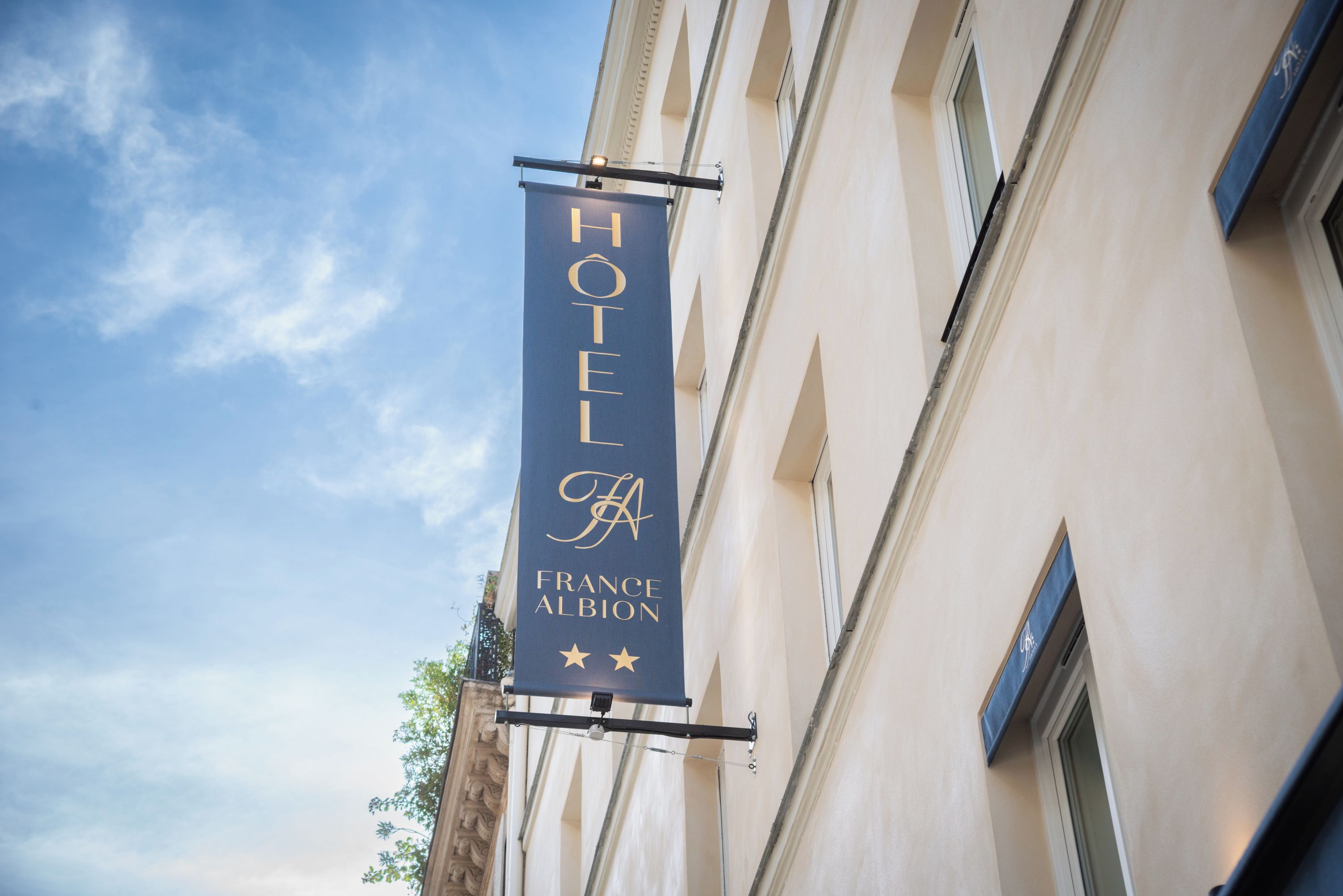 A hotel sign with 'HOTEL' and 'FRANCE ALBION' written on it.