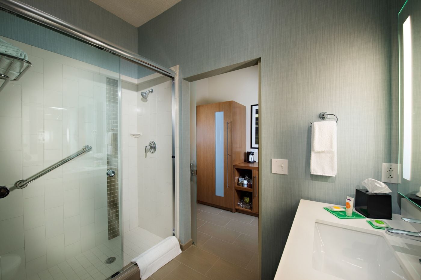 designer toiletries, hair dryer, towels