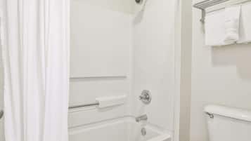 A bathroom with a bathtub, a shower, and a toilet.